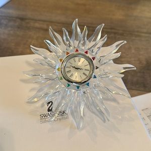 Swarovski clock with authenticity certificate.